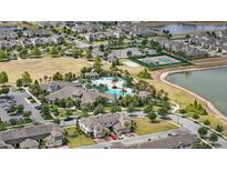 Beautiful aerial view of community amenities including a pool, tennis court, and pristine landscaping surrounding the homes at 16163 Pebble Bluff Loop, Winter Garden, FL 34787