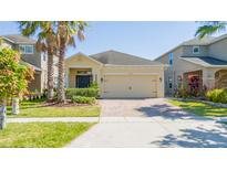 Charming one-story home with a two-car garage, brick driveway, and well-maintained landscaping at 2790 Monticello Way, Kissimmee, FL 34741