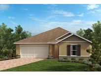 Charming single-story home featuring a two-car garage and a well-manicured lawn at 3481 Sanctuary Dr, Clermont, FL 34714