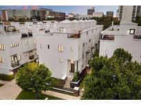 Modern multi-level townhouse showcasing sleek lines and rooftop terraces in a vibrant urban setting at 356 S Osceola Ave # 19, Orlando, FL 32801