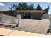 Charming single-story home with brick driveway and white picket fence at 4251 Anthony Lane, Orlando, FL 32822