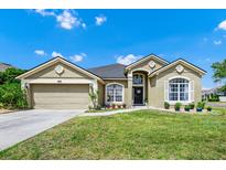 Charming single-story home with a well-manicured lawn, front-facing garage and beautiful desert landscaping at 5431 White Heron Pl, Oviedo, FL 32765