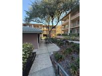 A community area featuring a picnic table, grill, and mature tree in a courtyard setting of an apartment complex at 128 Water Front Way # 300, Altamonte Springs, FL 32701