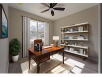 Bright office space with a ceiling fan, wooden desk, and a built-in bookshelf for storing and displaying your reading collection at 59 W 10Th St, Apopka, FL 32703