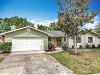 Charming single-story home featuring a well-manicured lawn, a spacious garage, and a welcoming entrance with tasteful landscaping at 236 N Ranger Blvd, Winter Park, FL 32792