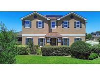 Charming two-story home with manicured landscaping and classic architectural details at 3008 Cardillino Way, Kissimmee, FL 34741