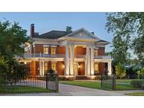 Stately brick home with classic architectural details, towering columns, and a beautifully landscaped front yard at 690 E Church St, Bartow, FL 33830