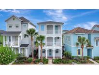 Charming three-story home with double balconies and lush tropical landscaping at 8044 Lost Shaker Ln, Kissimmee, FL 34747
