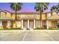 Inviting two-story townhome featuring a landscaped yard and convenient parking at 17349 Serenidad Blvd, Clermont, FL 34714