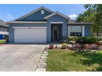 Charming single-story home featuring an attached garage and lush landscaping at 1868 Rachels Ridge Loop # L, Ocoee, FL 34761
