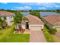Stunning lakefront home featuring a beautiful tile roof and meticulously manicured landscaping at 2173 Lake Side Ave, Davenport, FL 33837