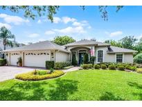 Charming single-story home with a well-manicured lawn, paver driveway and mature landscaping at 224 Bluestone Pl, Casselberry, FL 32707