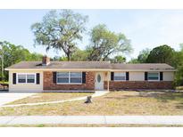 Charming single-story home features a brick accent, inviting front entrance, and well-maintained lawn at 4070 Mcneil Rd, Apopka, FL 32703