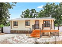 Charming single-story home with a freshly painted exterior and a landscaped walkway leading to the front door at 4922 Huppel Ave, Orlando, FL 32811