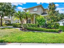 Charming two-story home with landscaped front yard, palm trees, and manicured hedges at 8448 Greenbank Blvd, Windermere, FL 34786