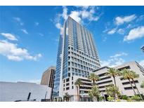 Modern high-rise building with sleek architecture and beautiful sky views in a vibrant city setting at 150 E Robinson St # 801, Orlando, FL 32801