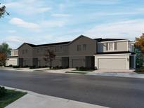 Charming two-story townhomes with attached garages and well-manicured landscaping create inviting curb appeal at 16430 Bird Of Paradise Ave, Clermont, FL 34714