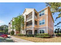 Beautiful multi-story condominium with screened patios, lush landscaping, and well-maintained grounds at 3480 Soho St # 107, Orlando, FL 32835