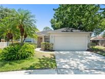 Charming single-story home with a well-manicured lawn, mature landscaping, and a two-car garage at 4306 Pebblestone Ct, Orlando, FL 32826