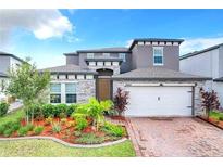 Charming two-story home with brick-paved drive and landscaped yard at 5637 Beggs Road, St Cloud, FL 34771