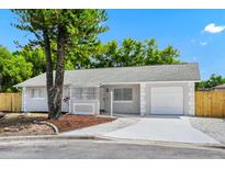 Charming single-story home showcasing a freshly painted exterior, well-manicured landscaping, and a one-car garage at 4710 Hatteras Ct, Orlando, FL 32808