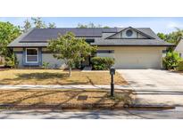 Charming single-story home featuring solar panels, a two-car garage, and a well-maintained front yard at 1134 Shaffer Trl, Oviedo, FL 32765