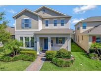 Charming two-story home featuring manicured landscaping and a welcoming front porch at 16137 Azure Key St, Winter Garden, FL 34787