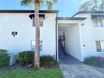 Condo exterior with landscaped entrance and stairwell access at 4405 S Semoran Blvd # 4, Orlando, FL 32822
