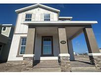 Charming home featuring a covered porch with stone accents and a welcoming facade at 5330 Center Lake, St Cloud, FL 34771