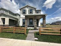 Charming two-story home featuring a covered front porch and a well-maintained lawn with a wooden fence at 5330 Center Lake, St Cloud, FL 34771