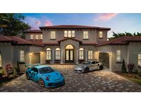 Stunning two-story home with a tile roof, paver driveway, and beautiful landscaping at 11019 Kentmere Ct, Windermere, FL 34786