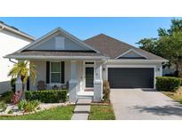 Charming single-story home featuring a well-maintained front yard and attached two-car garage at 13609 Riggs Way, Windermere, FL 34786