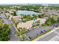 A beautiful aerial view of a condo community with lake, lush landscaping, and ample parking at 200 Maitland Ave # 224, Altamonte Springs, FL 32701