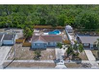 Charming home featuring a private pool, fenced yard, shed, and lush surrounding greenery at 2763 E Waco Dr, Deltona, FL 32738