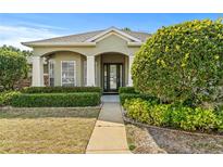 Charming single-story home with a well-manicured lawn and inviting front entrance at 346 Hickory Springs Ct, Debary, FL 32713