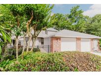 Charming townhome with lush landscaping, brick accents, and a two-car garage at 604 Chestnut Oak Cir # 106, Altamonte Springs, FL 32701