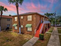 Charming two-story home featuring beautiful stucco siding, complemented by lush landscaping, and a inviting stairway at 707 Michigan Ct # 2, St Cloud, FL 34769