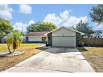 Charming single-story home featuring a well-maintained lawn and an attached two-car garage at 975 N Elder Rd, Sanford, FL 32771