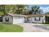 Charming single-story home featuring a two-car garage and well-maintained front lawn at 1051 Arden St, Longwood, FL 32750