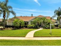 Beautiful home with lush landscaping, green lawn, and a winding walkway leading to the front door at 1121 Arbor Glen Cir, Winter Springs, FL 32708