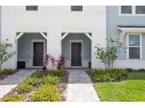 Charming townhouse exterior with well-maintained landscaping and inviting front entrance at 1286 Shoreside St, Clermont, FL 34714