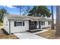 Charming single-story home with stone accents, fresh exterior paint, and updated landscaping at 14120 Rutgers Ave, Orlando, FL 32826