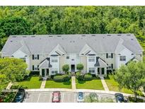 A charming townhome exterior showcasing well-manicured landscaping and ample parking spaces at 304 Southern Pecan Cir # 105, Winter Garden, FL 34787