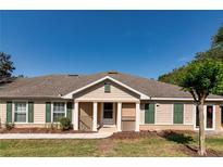 Charming single story home with beige siding, green shutters, and a welcoming front porch at 30546 Lipizzan Ter, Mount Dora, FL 32757