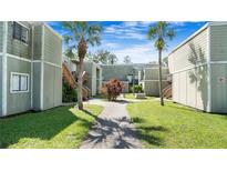 Charming courtyard view featuring lush landscaping and inviting walkways between attractive apartment buildings at 316 Scottsdale Sq # 316, Winter Park, FL 32792
