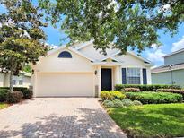 Charming single-story home featuring a two-car garage, manicured lawn, and well-maintained landscaping at 3506 Creswick Cir, Orlando, FL 32829