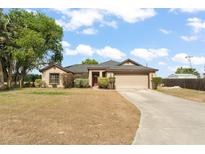 Charming single-story home featuring an attached garage and a well-manicured front yard at 43825 State Road 19, Altoona, FL 32702