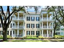 Condominium exterior featuring a facade with multiple balconies and white railings and black window shutters at 921 Begonia Rd # 302, Celebration, FL 34747