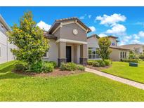 Charming single-Gathering home with a manicured lawn and beautiful landscaping at 9544 Mere Pkwy, Orlando, FL 32832