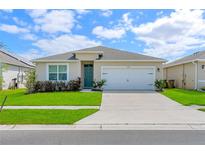 Charming single-story home with a well-maintained lawn and a two-car garage, creating great curb appeal at 1535 Barberry Dr, Kissimmee, FL 34744